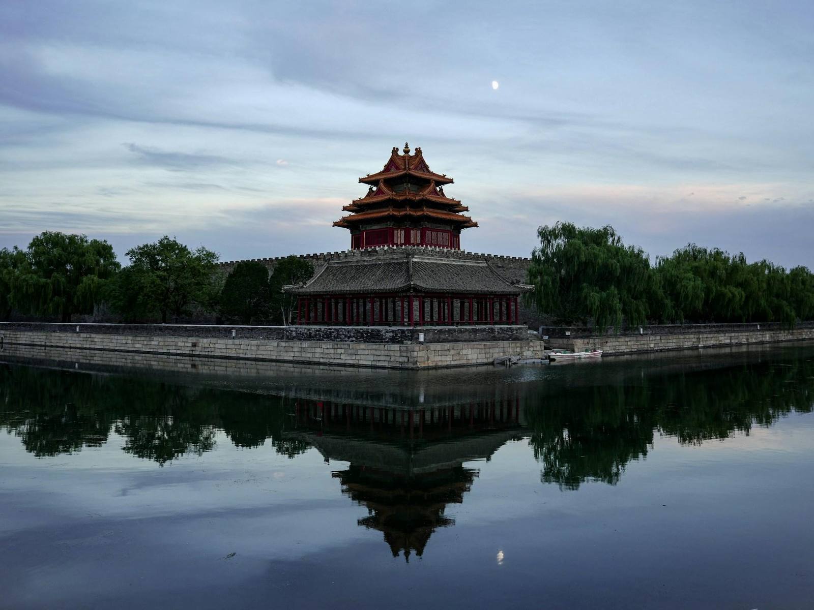 The Forbidden City's corner tower reflected in the moat