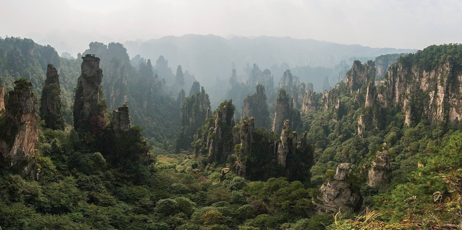 Quartz sandstone pillars of Tianzishan rising through haze in Zhangjiajie National Forest Park