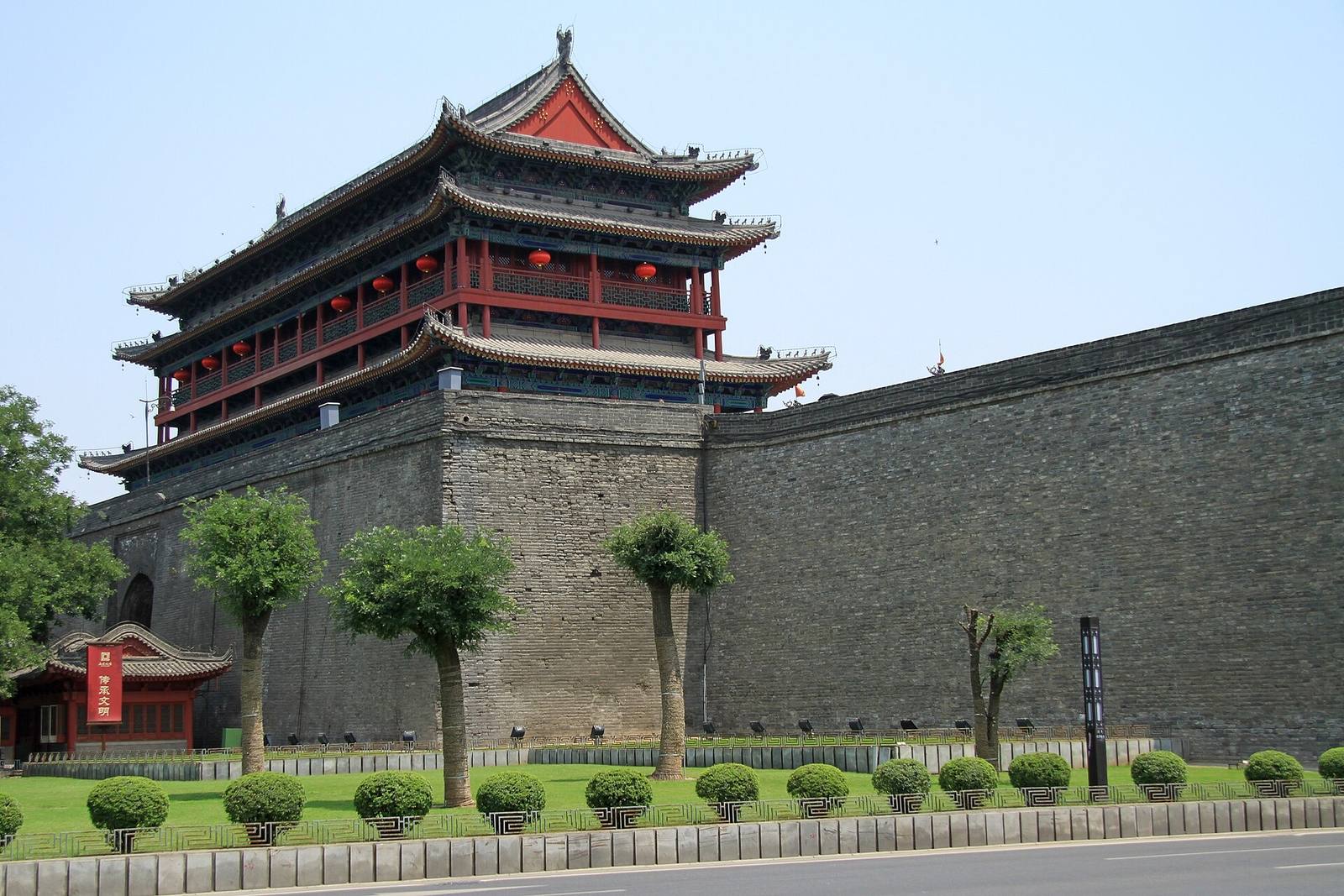 Xi'an's Ming-era gate tower and the long grey stretch of the city wall under a blue sky