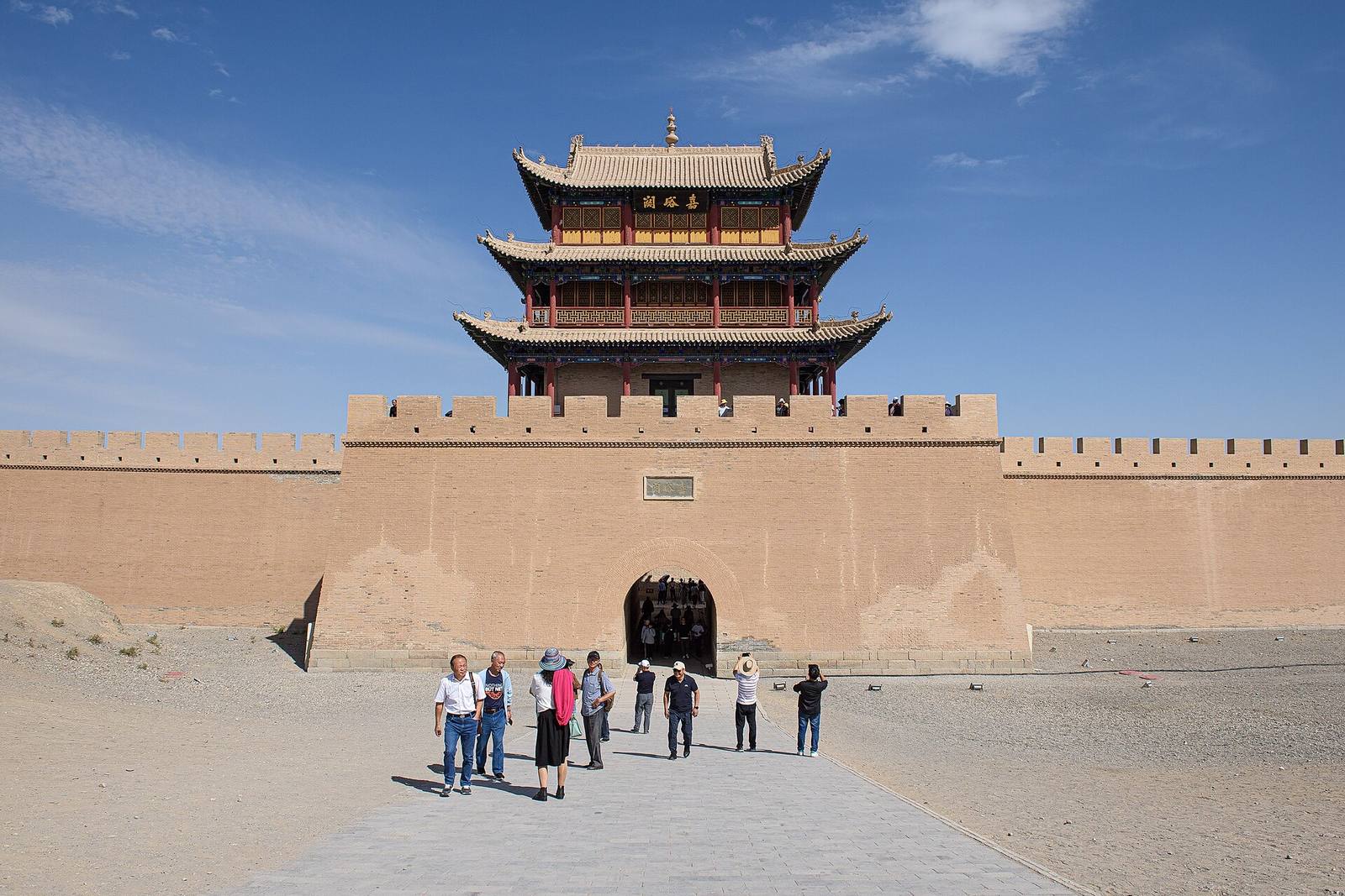 The Ming-dynasty gate tower and rammed-earth walls of Jiayuguan fort under a blue sky