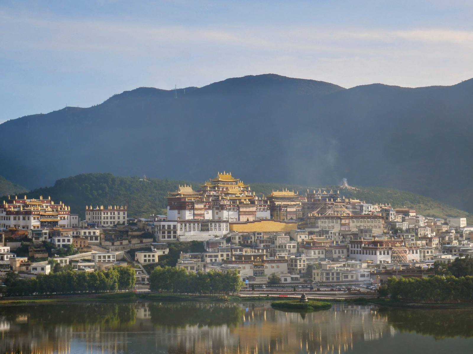 Songzanlin monastery at dawn, gilded roofs and incense smoke above its marsh
